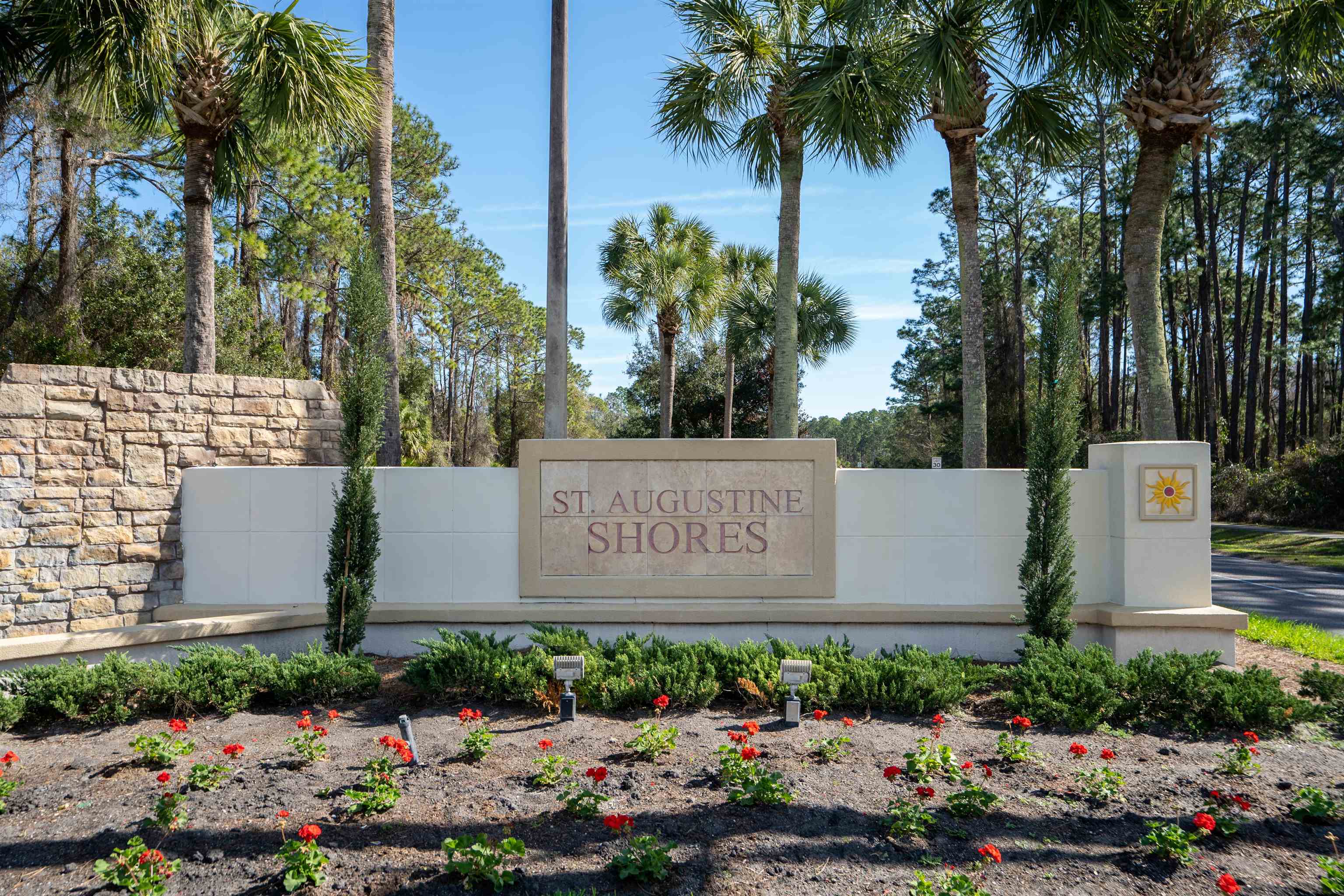 258 Costado Street St. Augustine, FL 32086 - Photo 25 of 39 a sign that is sitting in front of flowers
