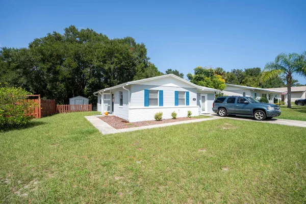 a front view of a house with a yard table and chairs