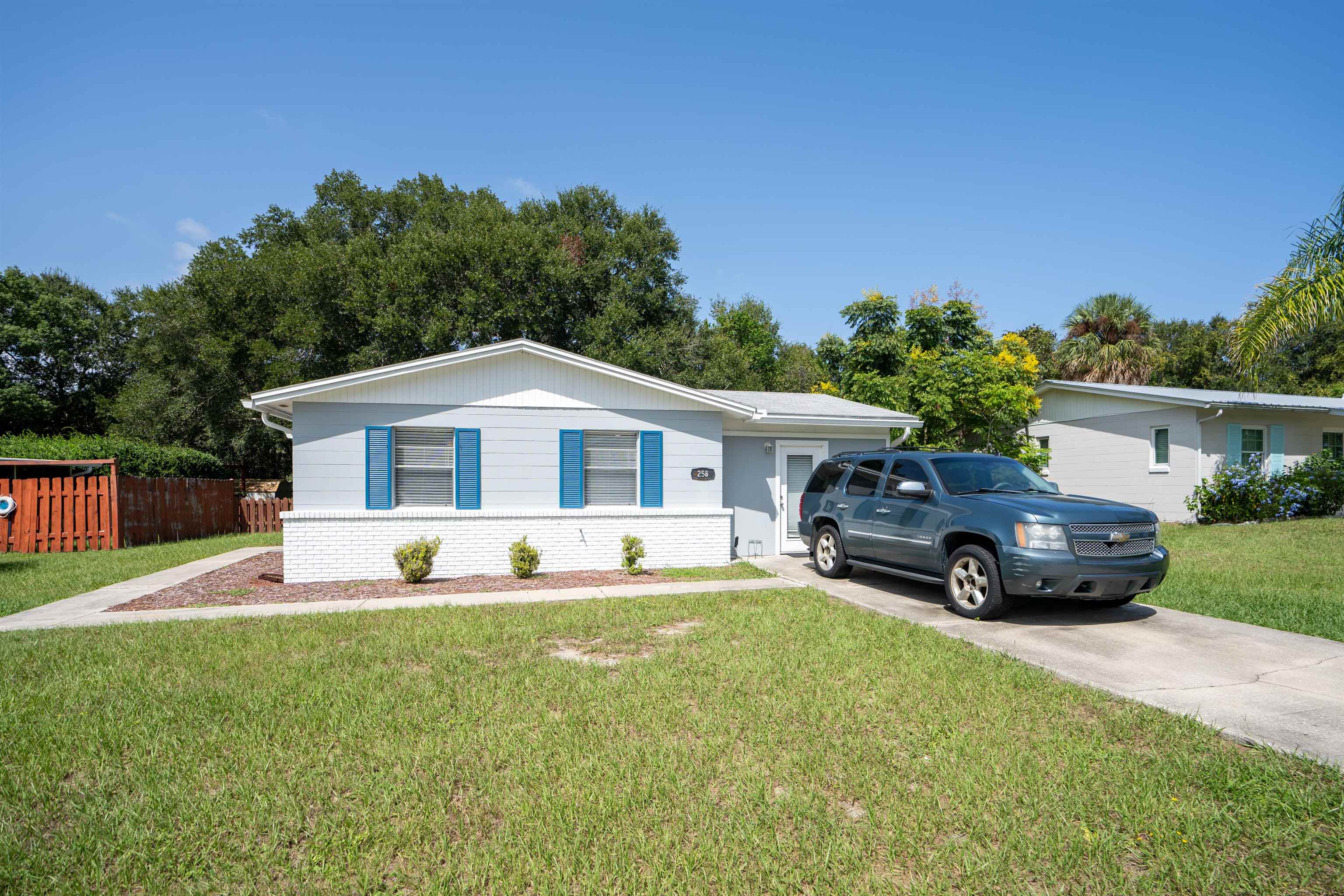 258 Costado Street St. Augustine, FL 32086 - Photo 5 of 39 a front view of a house with a yard and garage