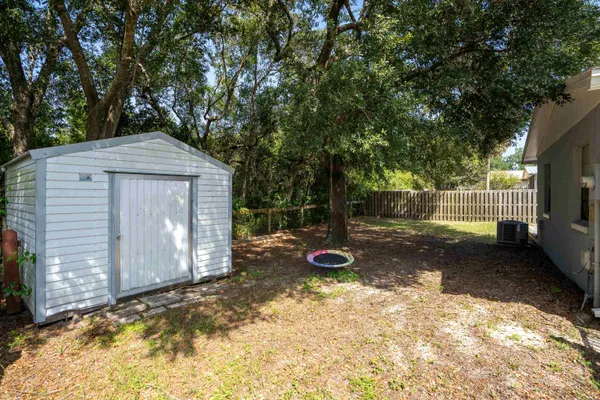a view of a backyard with a large tree