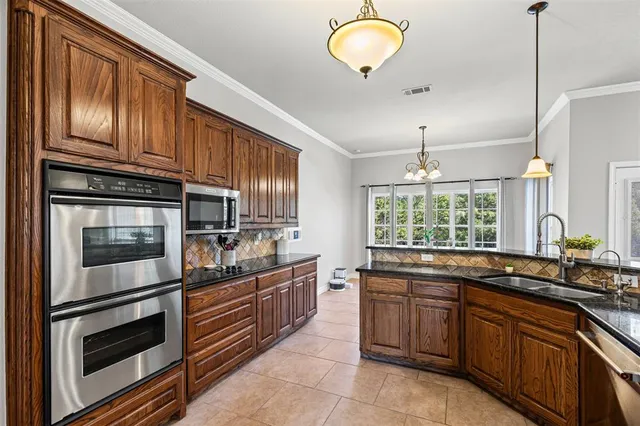 a kitchen with stainless steel appliances granite countertop a sink and stove