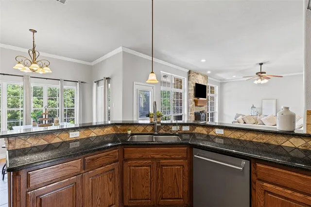 a kitchen with a sink and large window