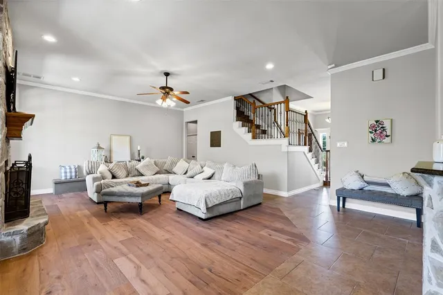 a living room with furniture and a chandelier