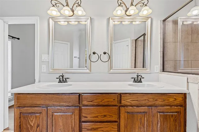 a bathroom with sink two mirror and