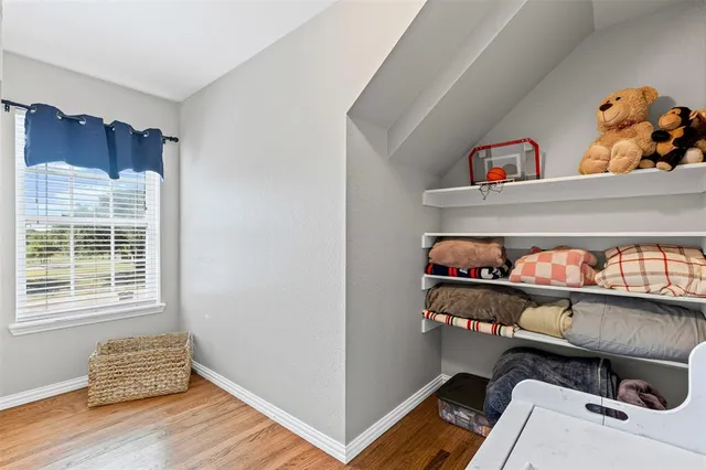 a room with wooden floor and furniture