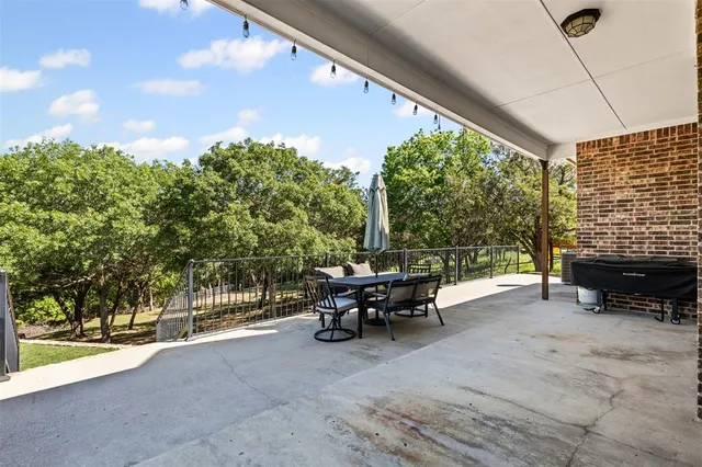 a view of a patio with table and chairs and potted plants