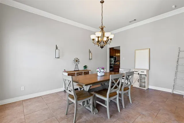 a view of a dining room with furniture and chandelier
