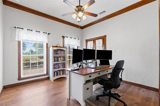a work room with furniture and wooden floor