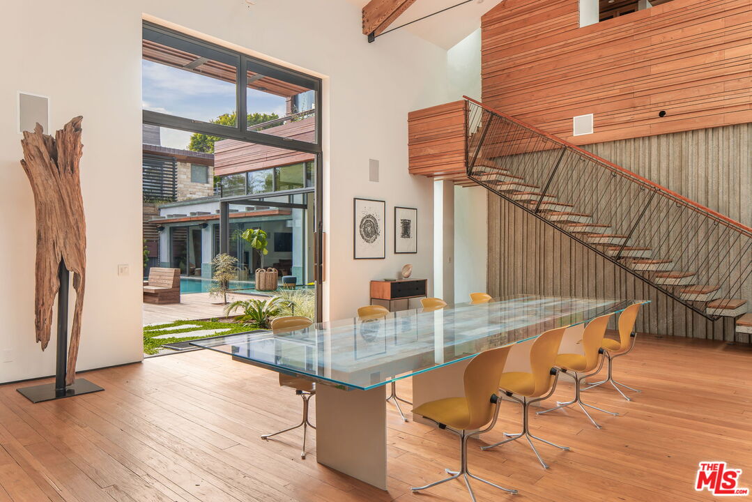 345 West Channel Road Santa Monica, CA 90402 - Photo 13 of 35 a view of a living room and kitchen floor to ceiling window and wooden floor