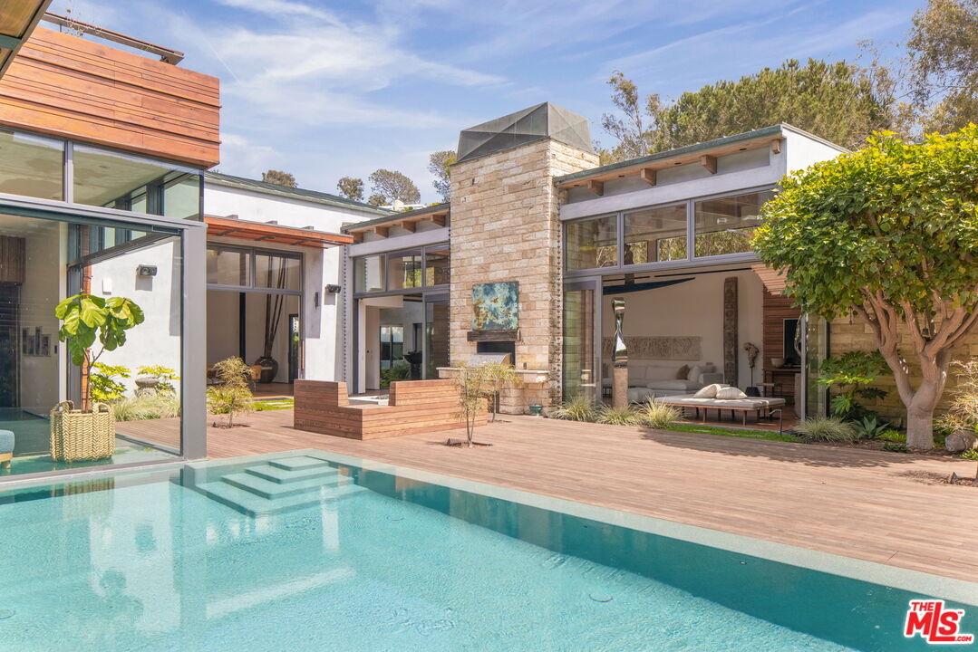 345 West Channel Road Santa Monica, CA 90402 - Photo 14 of 35 a building exterior with furniture and garden view