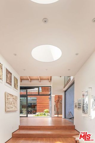 a dining room with wooden floor and furniture