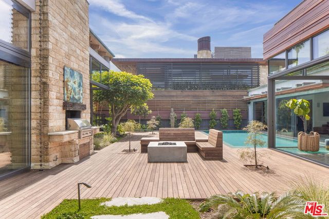 a view of a patio with couches and table potted plants