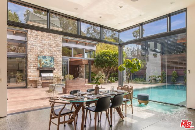 a view of a house with a patio and a yard