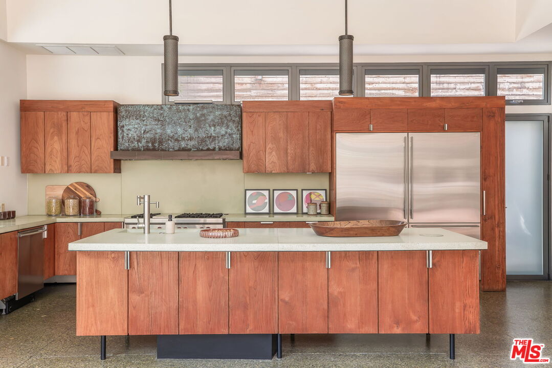 345 West Channel Road Santa Monica, CA 90402 - Photo 7 of 35 a kitchen with stainless steel appliances granite countertop a sink a stove and a wooden cabinets