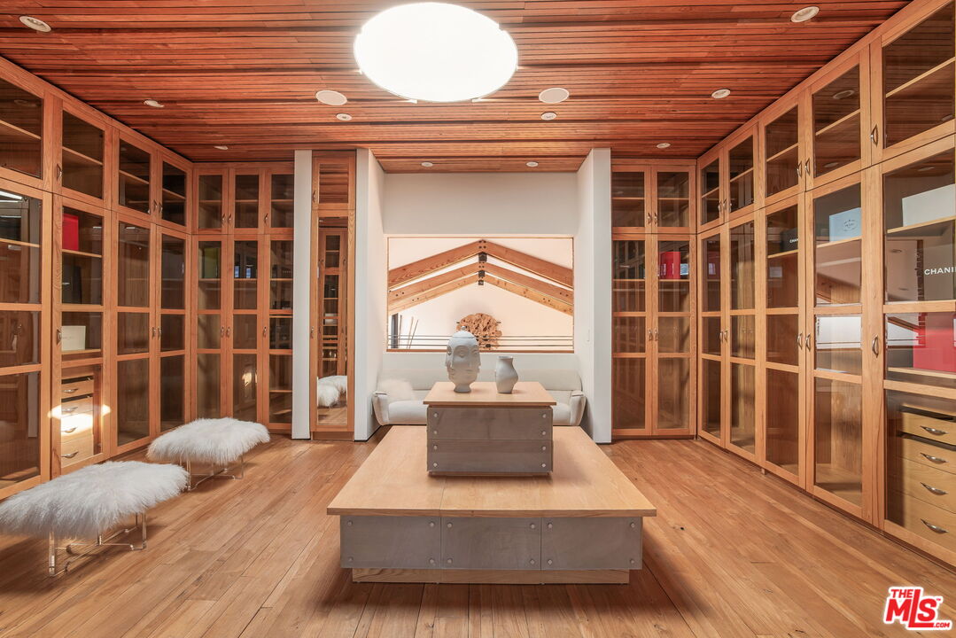 345 West Channel Road Santa Monica, CA 90402 - Photo 8 of 35 a bedroom with a bed and a chandelier