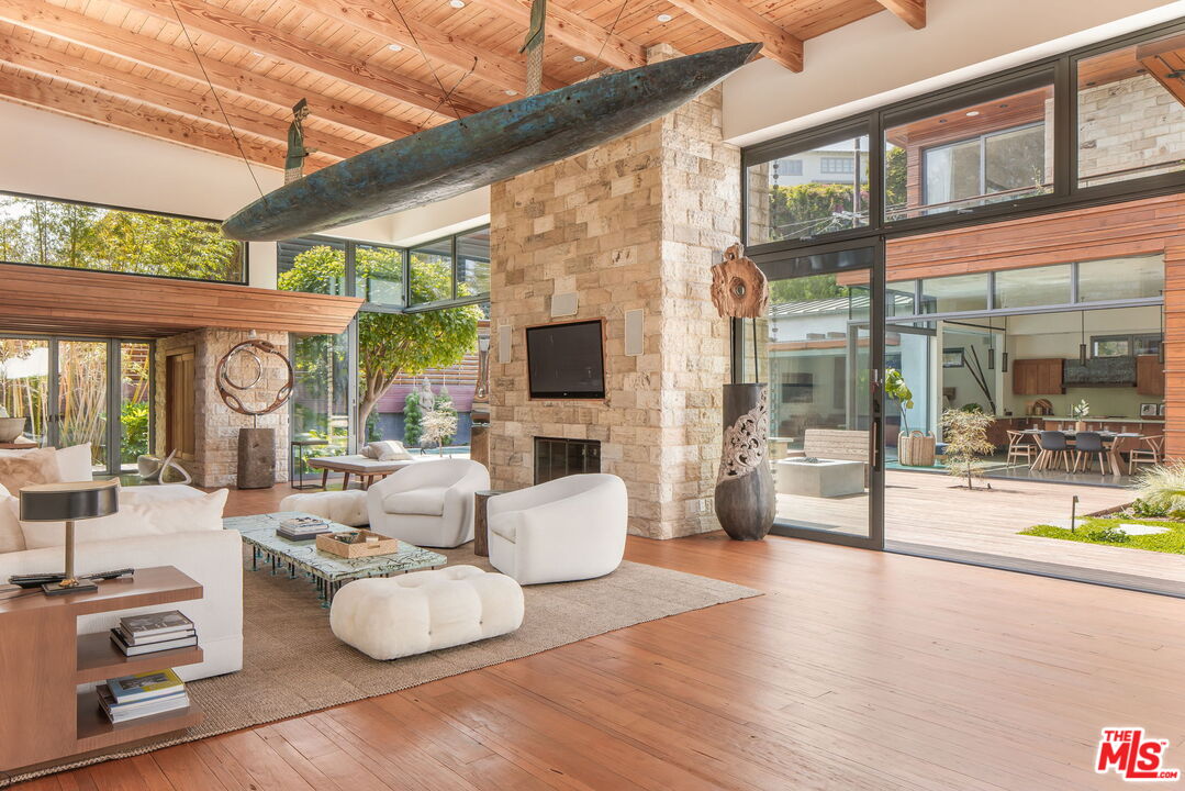 345 West Channel Road Santa Monica, CA 90402 - Photo 9 of 35 a room with furniture large windows and wooden floor