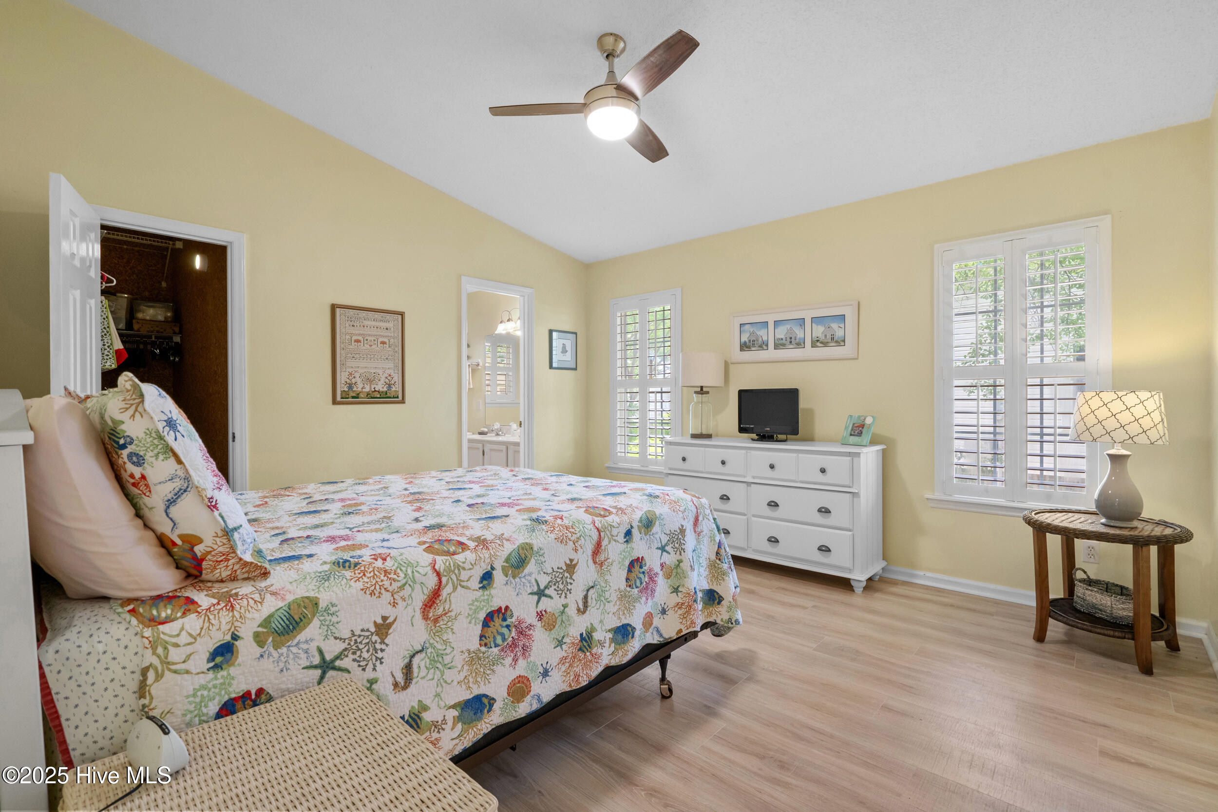 396 Deer Path Calabash, NC 28467 - Photo 11 of 33 The Owner's Suite has a spacious walk-in closet, a ceiling fan, and an attached ensuite bathroom.