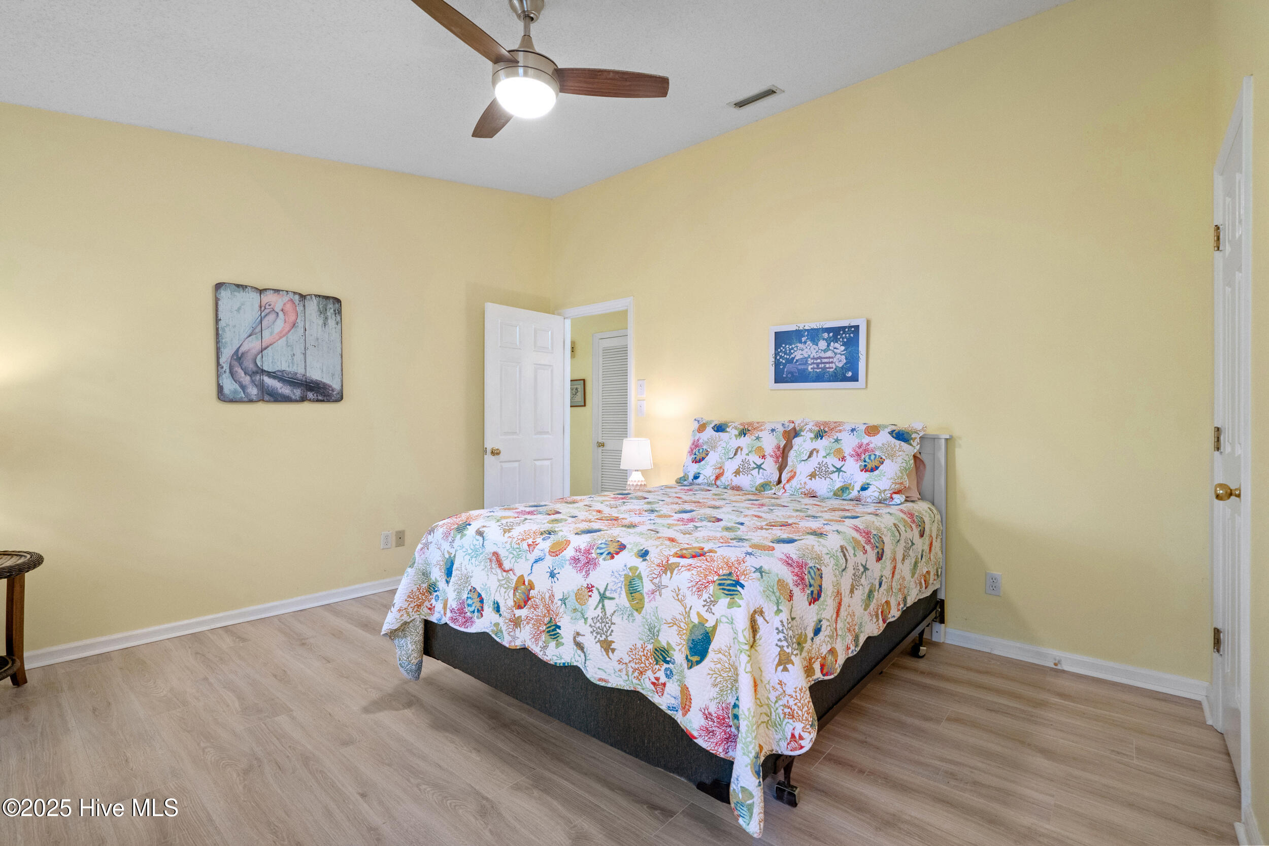 396 Deer Path Calabash, NC 28467 - Photo 12 of 33 Owner’s suite features a spacious walk-in closet, a ceiling fan, and a private ensuite bathroom.