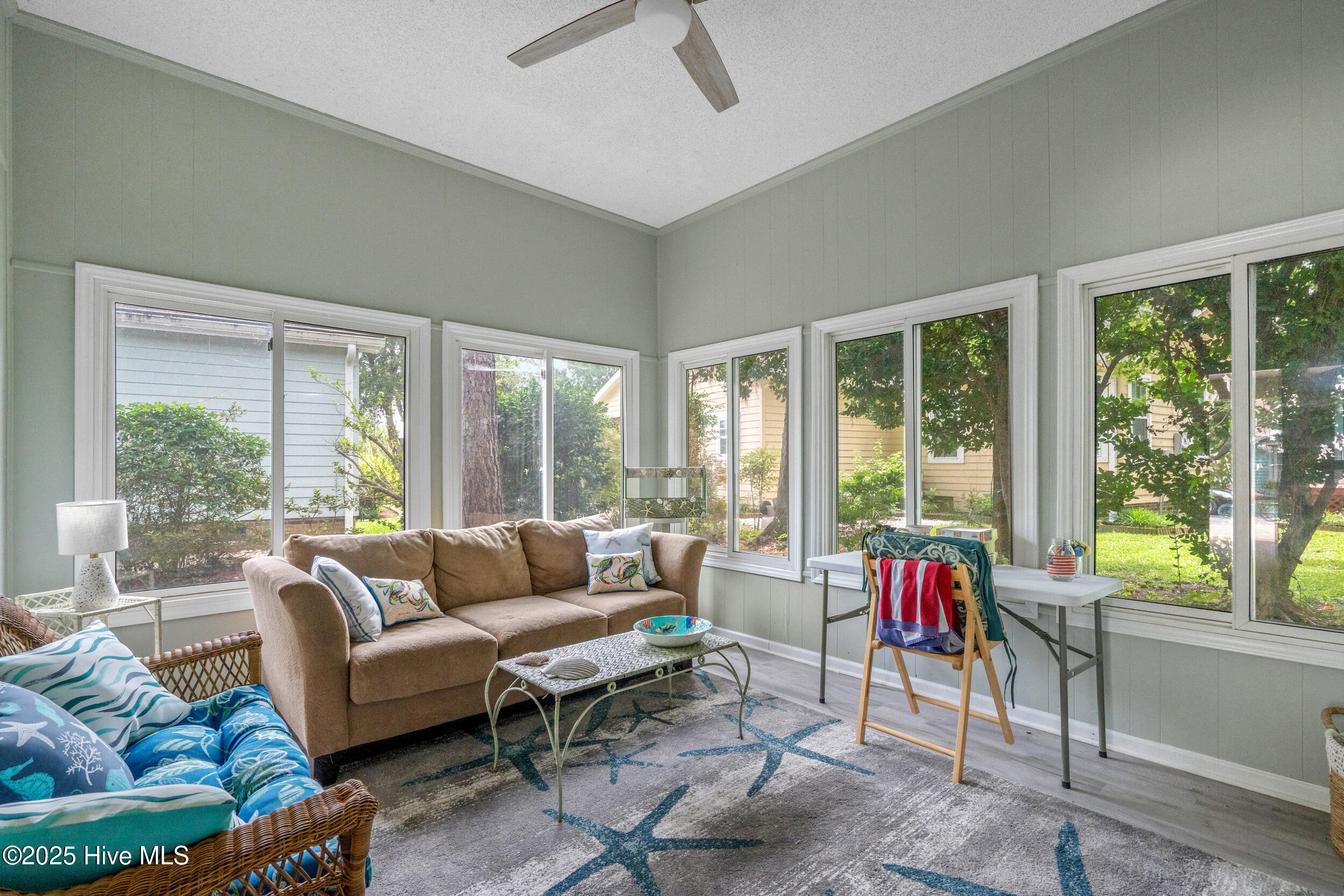 396 Deer Path Calabash, NC 28467 - Photo 22 of 33 The Sun Room, with its advantageous location, natural illumination, becomes a harmonious blend of indoor and outdoor living. This room is NOT included in the heated square footage. There is a wall unit behind the couch.