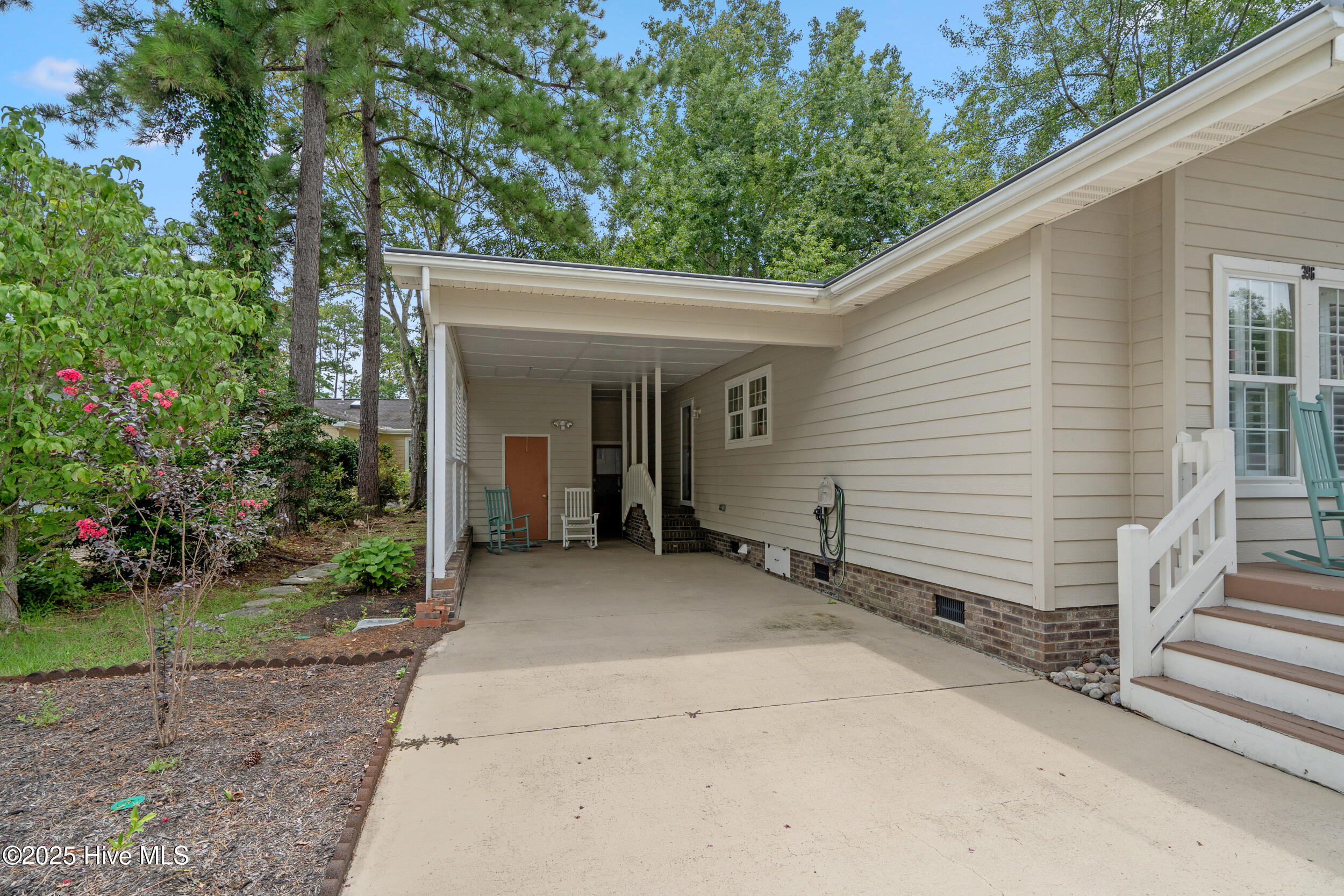 396 Deer Path Calabash, NC 28467 - Photo 24 of 33 This home features a convenient attached carport that offers sheltered parking just steps from your side door and your front door. From the carport, you’ll find direct access to a spacious storage area—perfect for keeping tools, seasonal décor, or outdoor gear neatly organized.