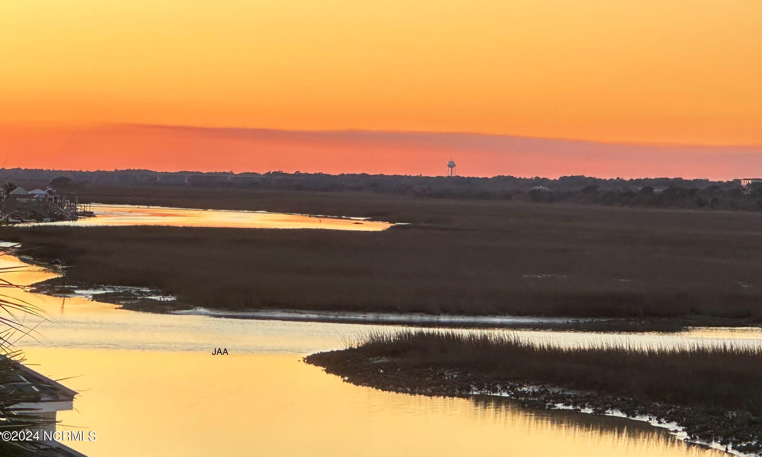 396 Deer Path Calabash, NC 28467 - Photo 32 of 33 Watching the sun set over the creek can be a breathtaking experience. As the sun descends, it often paints the sky with vibrant hues, casting a warm glow over the water. The tranquil setting of Jinks Creek provides a serene backdrop for enjoying the beauty of the natural surroundings.