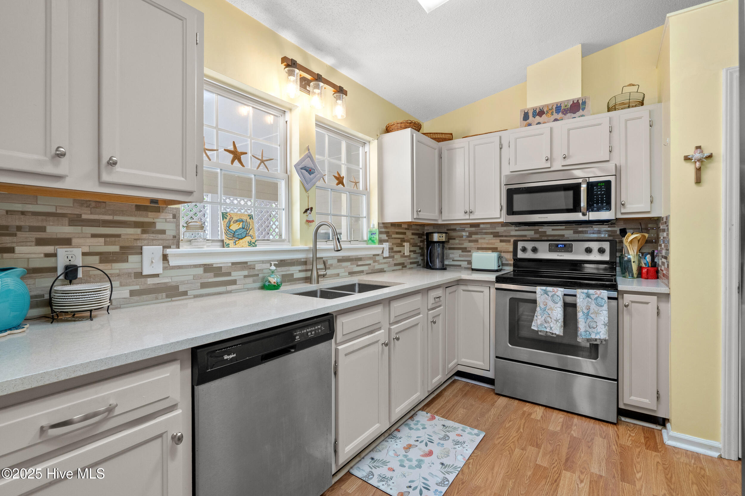 396 Deer Path Calabash, NC 28467 - Photo 6 of 33 Solid-surface countertops, tile backsplash, skylight, and all kitchen appliances included.