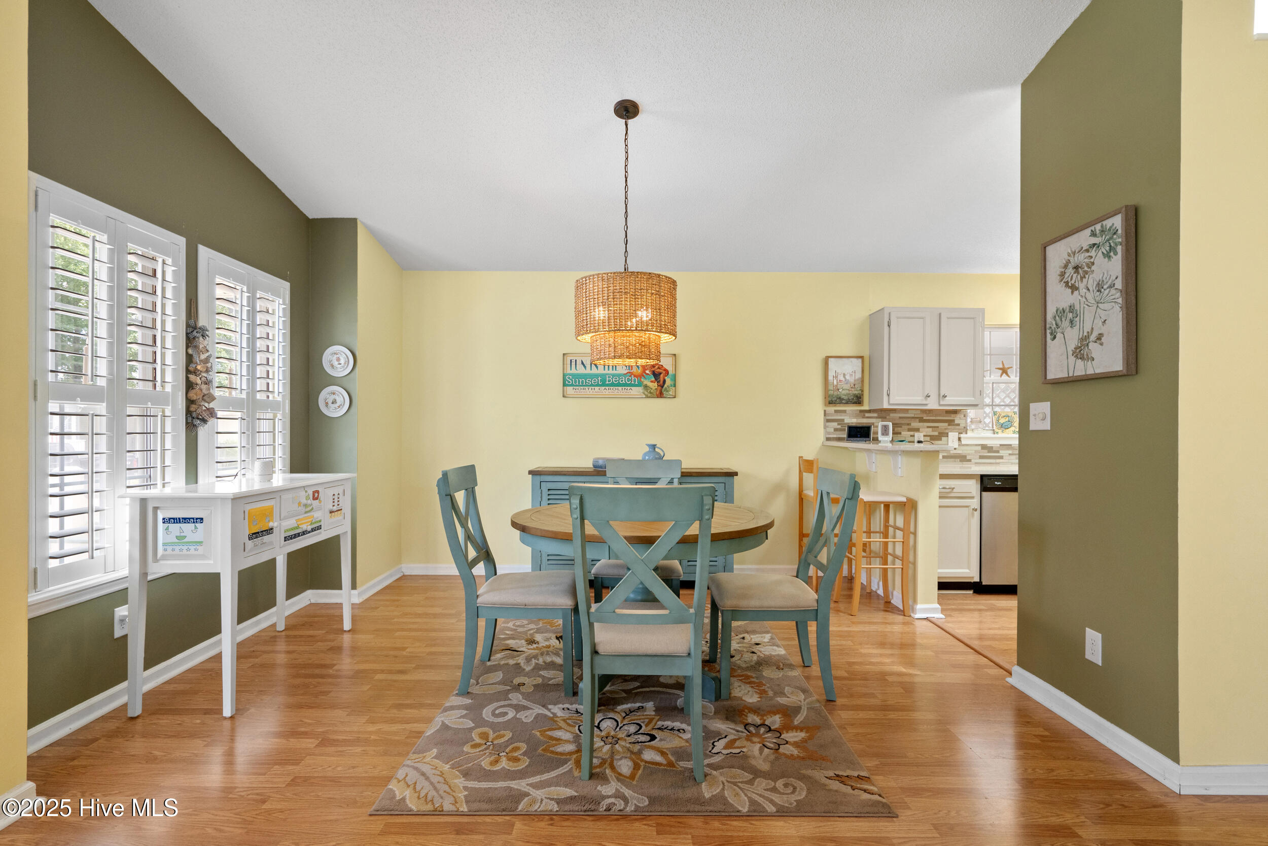 396 Deer Path Calabash, NC 28467 - Photo 10 of 33 The dining area is conveniently located right off the kitchen and is a practical and inviting feature that seamlessly blends functionality with sociability. This layout not only enhances the flow of daily activities, but also creates a warm and communal atmosphere within the home.