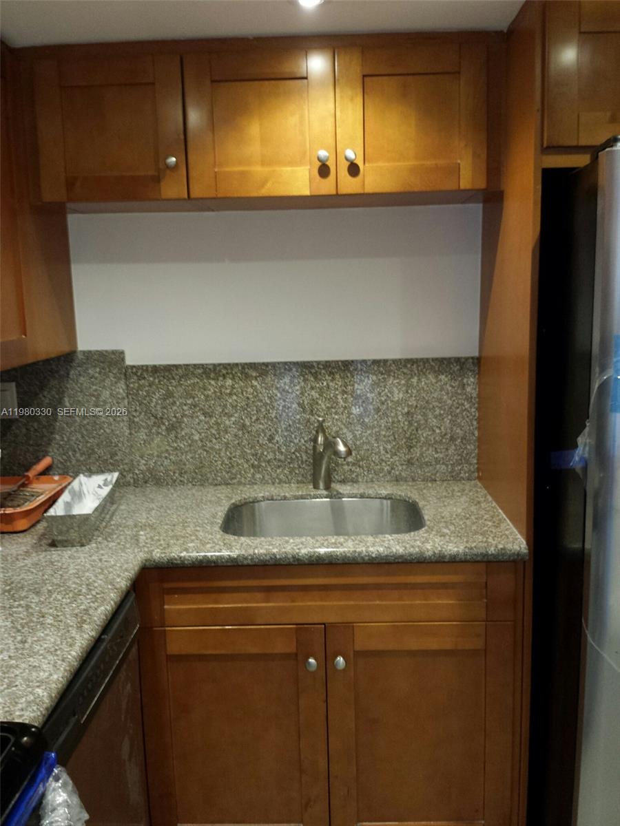 9441 Southwest 4th Street, Unit 302 Miami, FL 33174 - Photo 16 of 24 a kitchen with a sink and a refrigerator