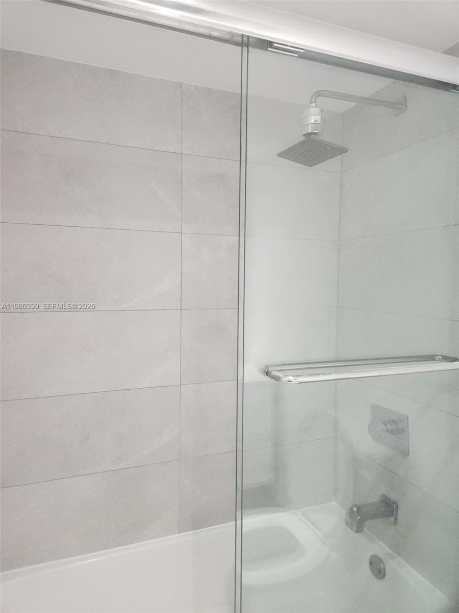9441 Southwest 4th Street, Unit 302 Miami, FL 33174 - Photo 23 of 24 a bathroom with a shower and a bath tub