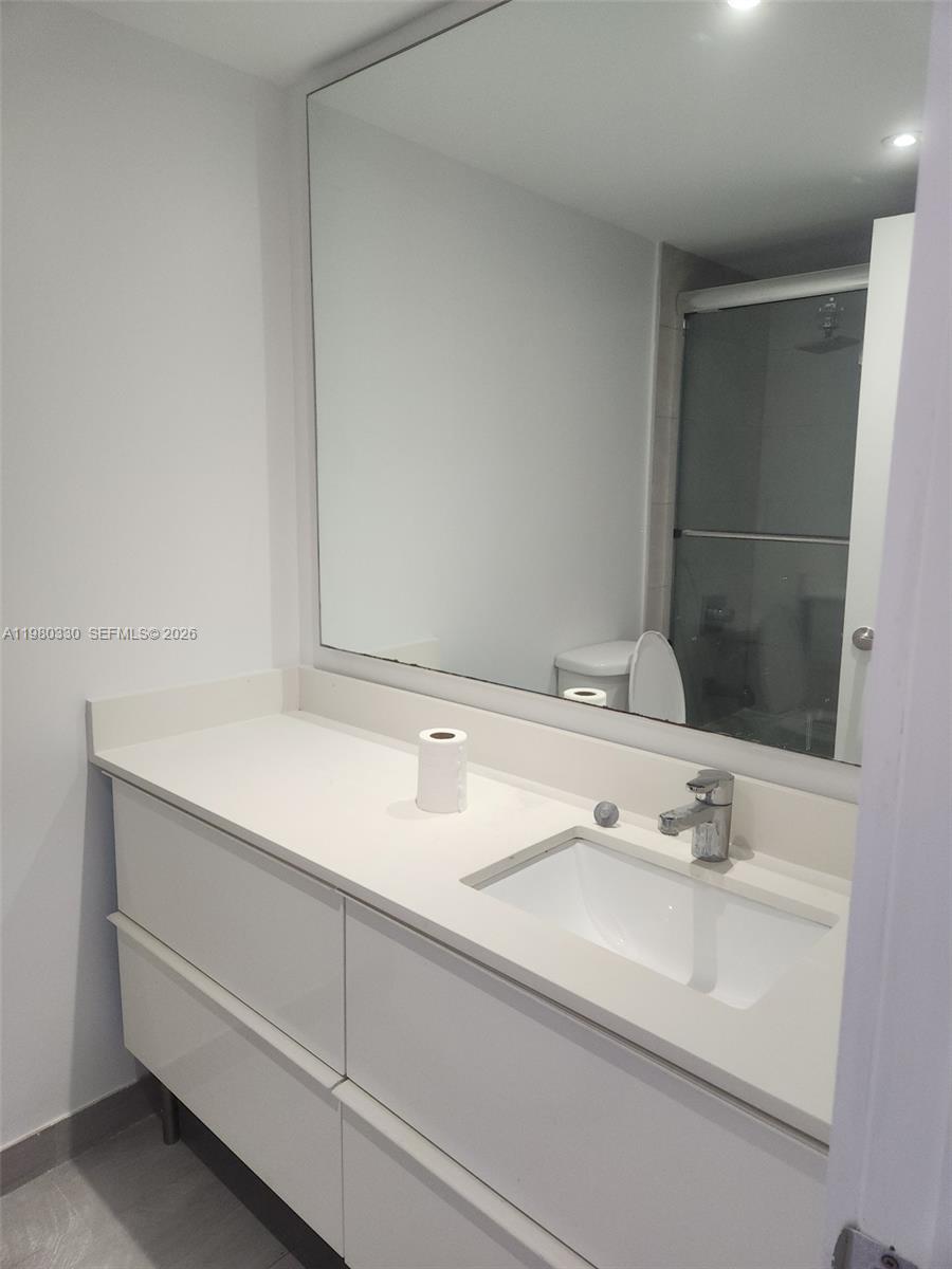 9441 Southwest 4th Street, Unit 302 Miami, FL 33174 - Photo 6 of 24 a bathroom with a sink and a mirror
