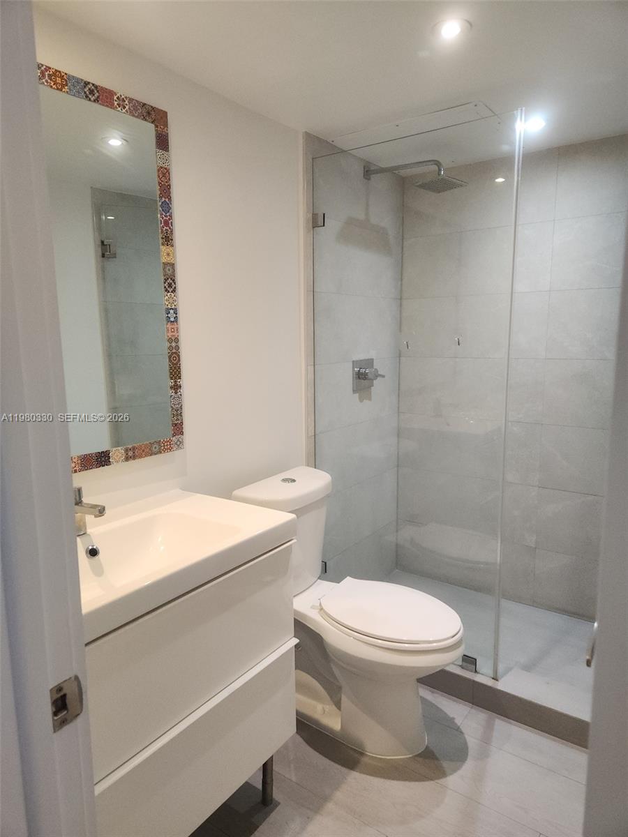 9441 Southwest 4th Street, Unit 302 Miami, FL 33174 - Photo 7 of 24 a bathroom with a sink a toilet and shower