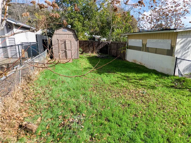 a front view of a house with a yard and potted plants