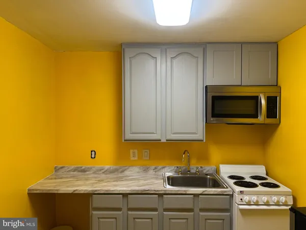 a kitchen with sink and cabinets