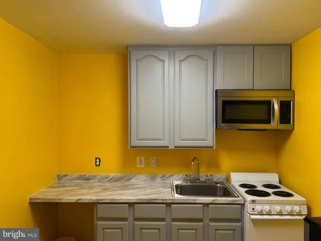 a kitchen with sink and cabinets