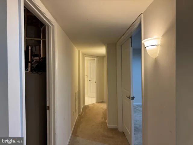 a view of a hallway with a wooden door