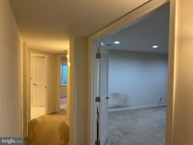 a view of a hallway with a room and bathroom
