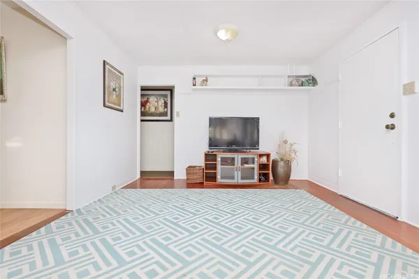 a room with a bed and a flat screen tv