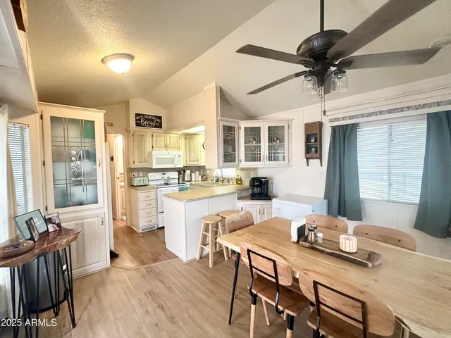 a large kitchen with a table and chairs