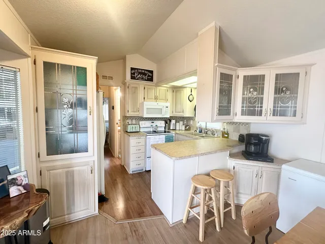 a kitchen with a sink cabinets and refrigerator