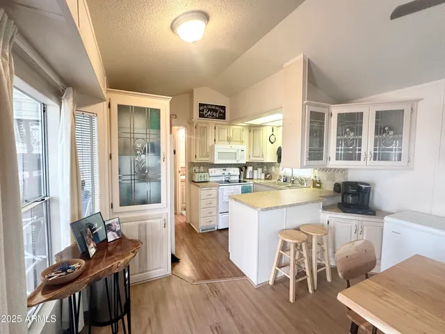 a kitchen with a sink stove and wooden floor