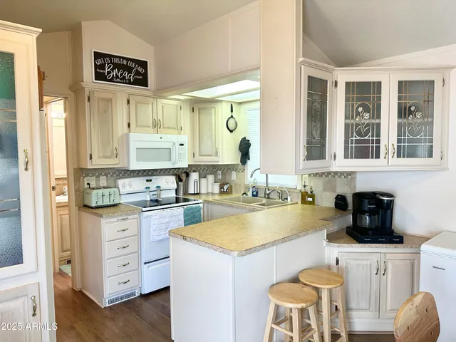 a view of a kitchen counter space wooden floor and a window