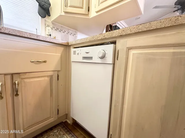 a kitchen with a sink cabinets and window