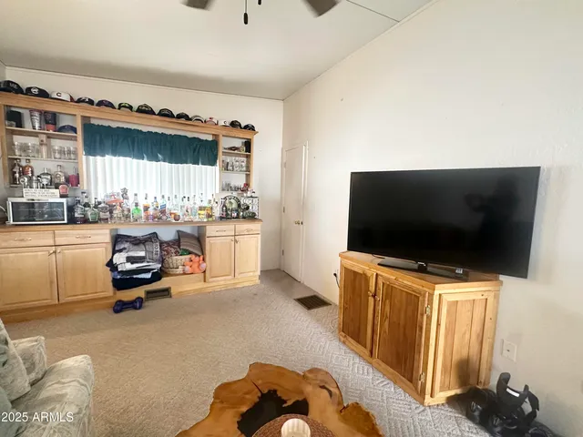 a view of a porch with a table and chairs and floor to ceiling window