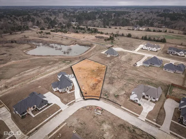 an aerial view of a house with yard