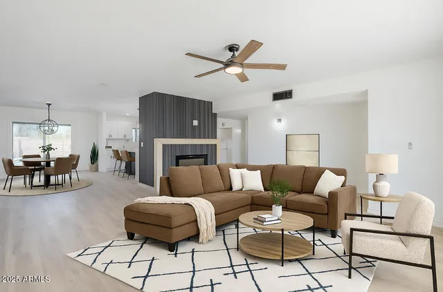 an empty room with a window and a fan