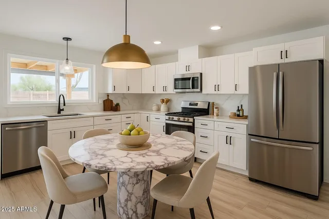 a view of an empty room with wooden floor and fence