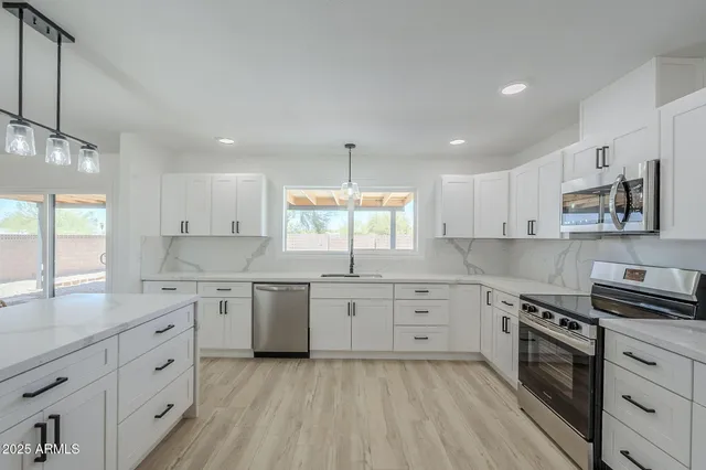 a view of a house with swimming pool and sitting area