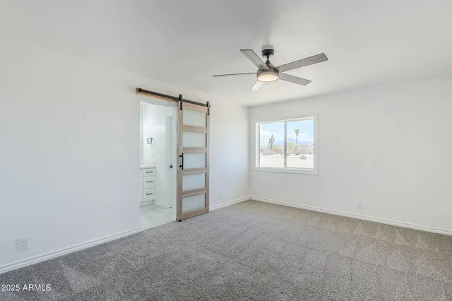 a front view of a house with a yard and potted plants