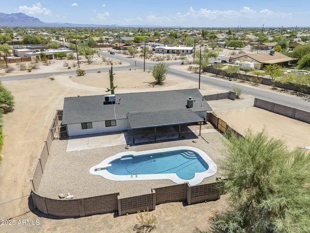 an empty room with wooden floor ceiling fan and windows