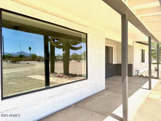 a kitchen with white cabinets stainless steel appliances a sink and a window
